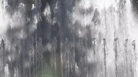 Backlit water flowing with reflections and splashes. Fountain in Milan, Italy Видео 129404752