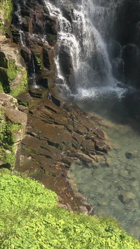 Backlit Waterfall Falling Down Rock Face Vertical Video 库存影片 346195402