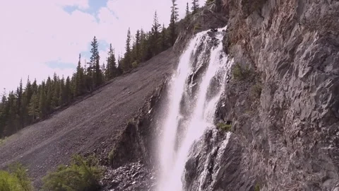 Backlit waterfall flows out of unseen ca... | Stock Video | Pond5