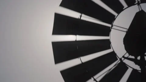 A backlit windmill in a salt field with lens flare, Arraial do Cabo, Brazil Stock Footage 140538758