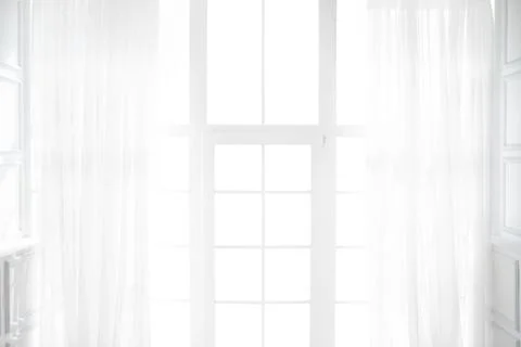 Backlit window with white curtains in empty room Stock Photos