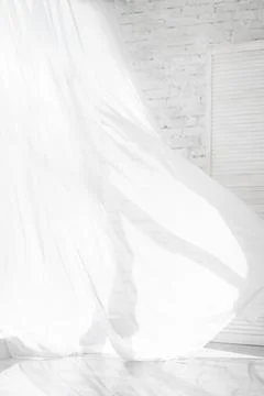 Backlit window with white curtains in empty room Stock Photos