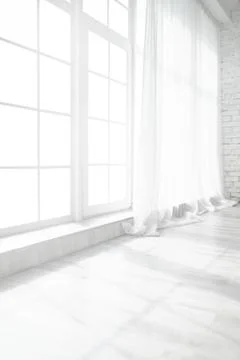 Backlit window with white curtains in empty room Stock Photos