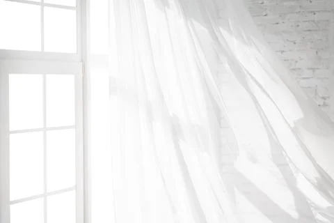 Backlit window with white curtains in empty room Stock Photos