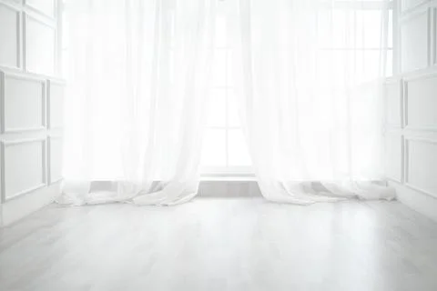 Backlit window with white curtains in empty room Stock Photos