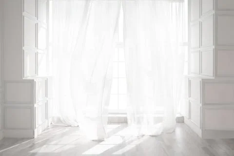 Backlit window with white curtains in empty room Stock Photos