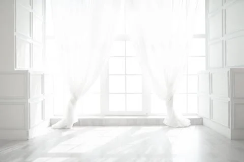 Backlit window with white curtains in empty room Stock-Fotos