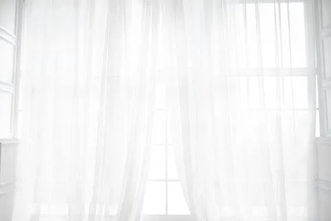 Backlit window with white curtains in empty room Stock Photos