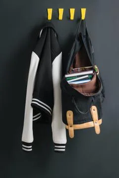 Backpack and jacket on the wall Stock Photos