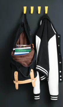 Backpack and jacket on the wall Stock-Fotos