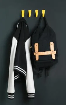 Backpack and jacket on the wall Stock Photos
