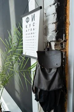 Backpack on the background of a palm tree and a poster Stock Photos