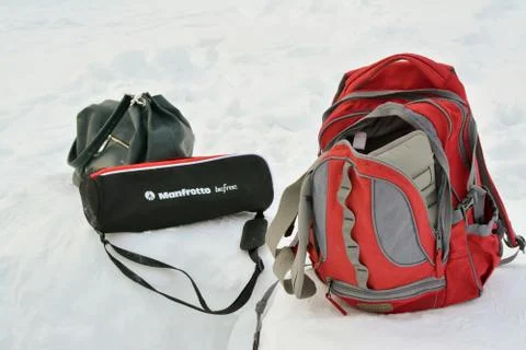 Backpack, bag, tripod in the snow. Preparing for video and photo shooting in Fotos Stock