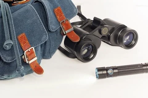 Backpack, binoculars, flashlight in close-up against a white background. Foto stock