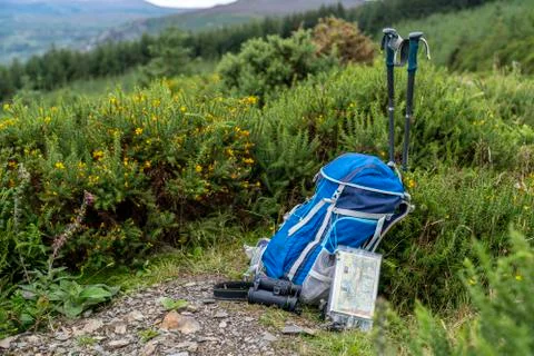 Backpack, binoculars, map and sticks on the mountain, mountain lifestyle in I Stock Photos