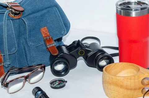 Backpack, compass, binoculars and flashlight, camping mug and thermos-a hik.. Stock Photos