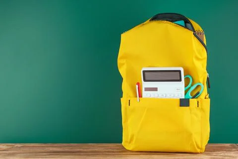 Backpack on the desk in the classroom. Stock Photos