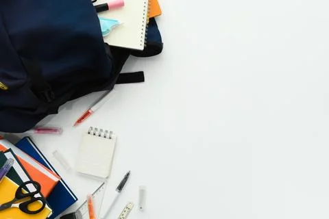 Backpack with different stationery on white background. International day of Stock Photos