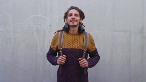 Backpack, headphones and face of student man outdoor for fashion, learning or Stock Footage 334735355
