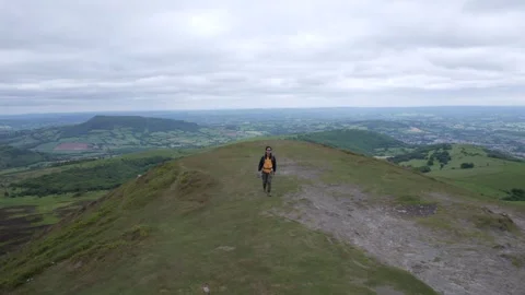 Backpack hiker on the Sugar Loaf, mountain peak, Abergavenny, Monmouthshire.. Video stock 277548344