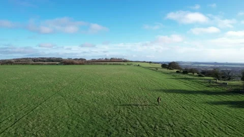 Backpack hiking man walking in field, winter in Pewsey, Wiltshire, England Stock-Footage 235065241