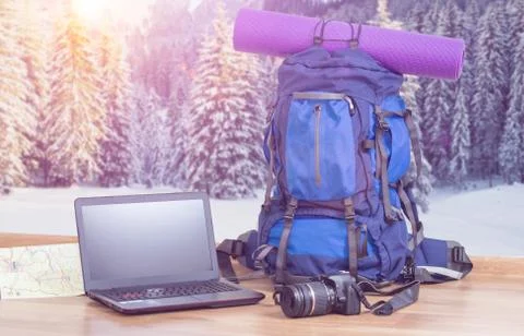 Backpack laptop and camera with winter background Stock Photos