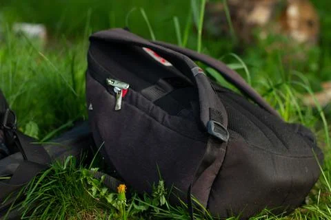 Backpack laying on grass Stock Photos