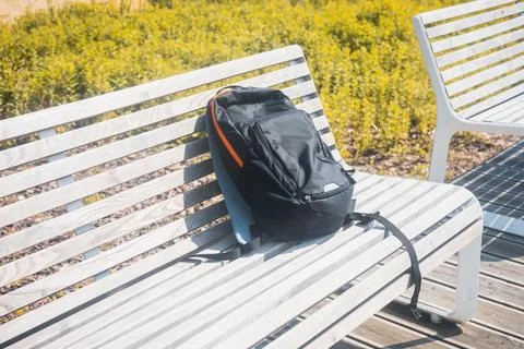 Backpack left on the bench, Concept, suspicious luggage, lost items Stock Photos