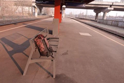 Backpack lost at a train station on a bench Stock Photos
