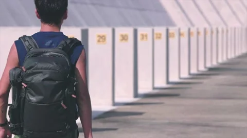 Backpack man walking along the dam of Plover Cove Reservoir, daytime Stock-Footage 162806365