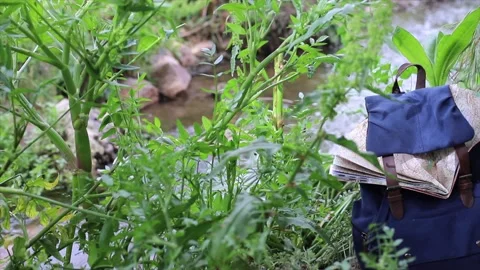 Backpack with a map, in a river, backpacker traveler Stock Footage 135730067