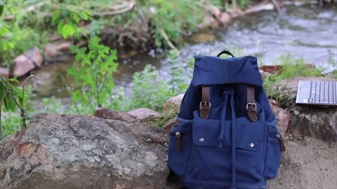 Backpack with a map, in a river, backpacker traveler Stock Footage 135730082