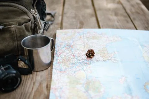 Backpack with maps and mug. Stock Photos