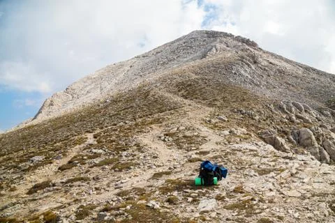 Backpack on mountain trail Stock Photos
