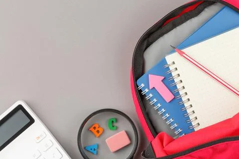 Backpack with notepad and study supplies. Stock Photos