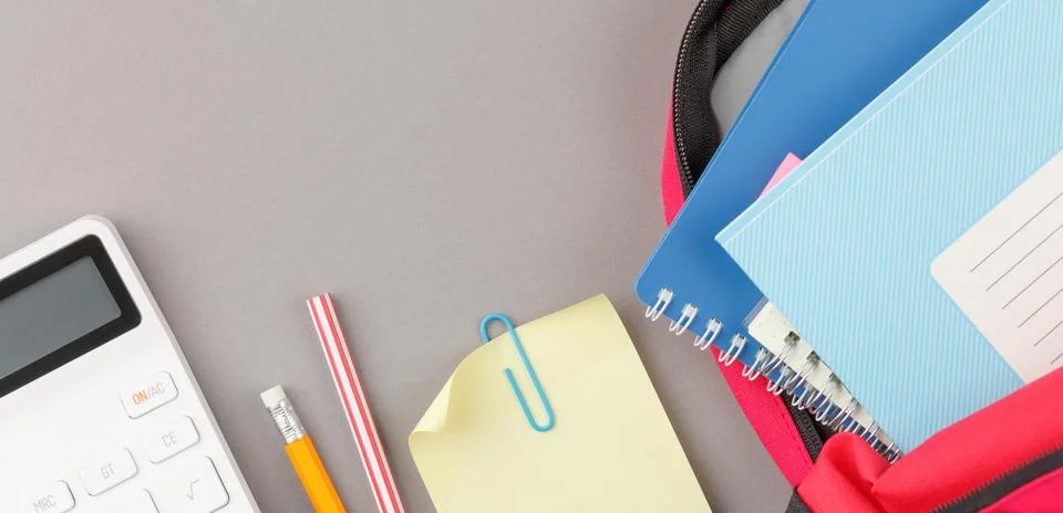 Backpack with notepad and study supplies. Stock Photos