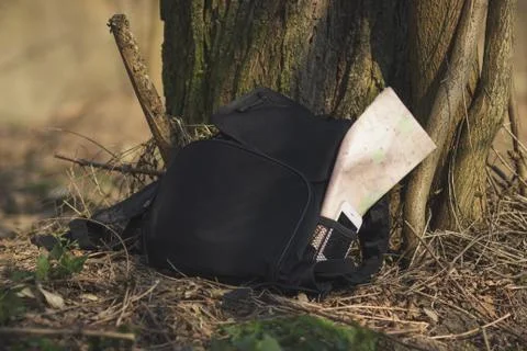 Backpack with phone and map in the pocket on the ground Fotos Stock