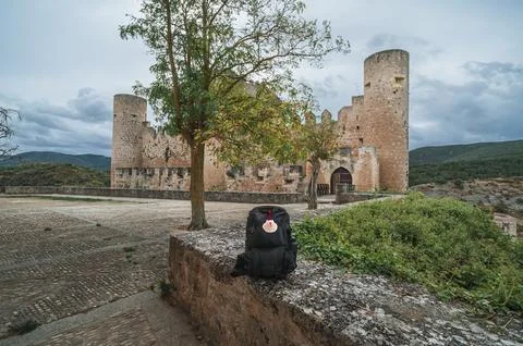 Backpack resting with a scallop shell symbol in Camino de Santiago Photos