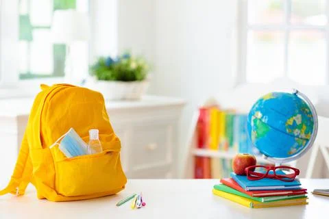 Backpack of school child. Face mask and sanitizer. Stock Photos