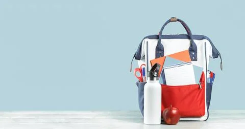 Backpack with school red and blue stationery with red apple Stock Photos