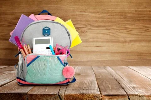 Backpack with school stationery on table against wooden background, space f.. 写真素材