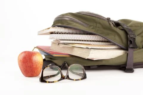Backpack with school supplies and apple on the side Stock Photos