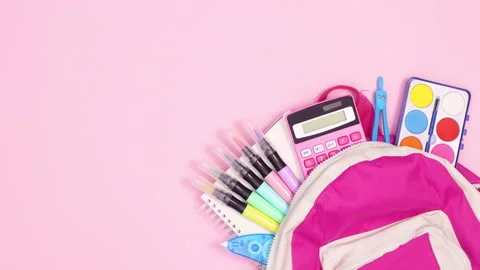 Backpack with school tools appear on right side of pink theme. Stop motion Stock Footage 157347166
