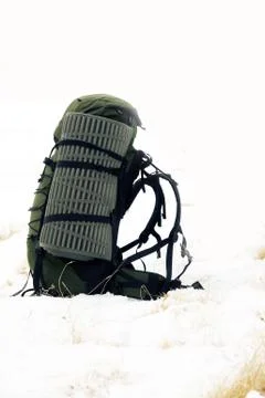 Backpack on a snow-covered field Stock Photos