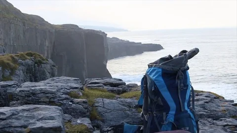 Backpack on top of cliff sliding shot Stock Footage 71810827