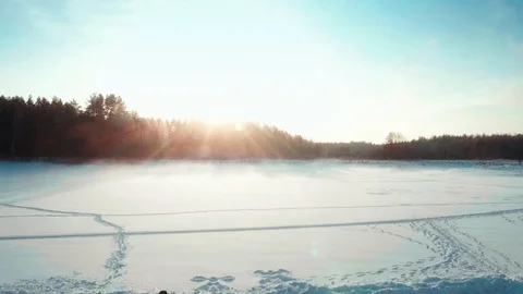 Backpack tourist walks through the field in winter. Sunset view 動画素材 123010683