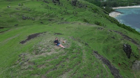 Backpack Traveler Observes Calm Turquoise Waters From High Perch 스톡 동영상 330198053