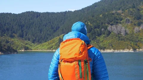 Backpacker On a Boat in Front of Land Stock Footage 111416163