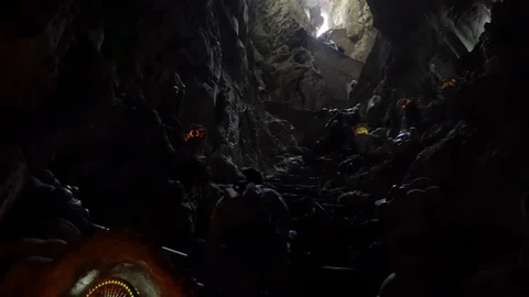 Backpacker climbing to the top of a cave Stock Footage 102293723