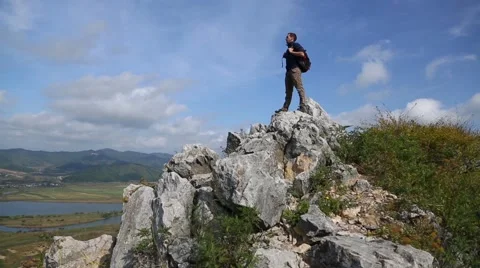 Backpacker climbs to the top of the mountain by autumn morning. Stock Footage 56698522